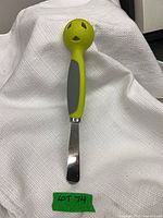 Front view of Pampered Chef avocado tool showing serrated blade and handle