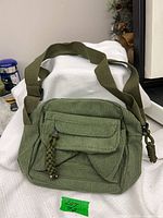 Front view of green corduroy crossbody purse
