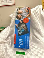 Front of boxed puzzle mat showing contents and size information