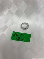 Ring lying flat showing vine pattern around band