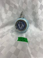 Front view showing wolf portrait medallion and blue speckled body