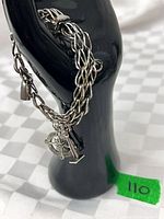 Bracelet draped on display showing overall design and charms