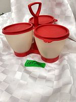 complete condiment set front view showing three cups with lids in carrier