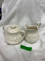 Creamer and lidded sugar bowl front view