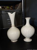 Both Lenox ivory vases side by side showing overall forms and gold trim