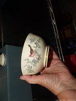 Side view of Lenox Serenade bowl showing floral and bird motif and gold rim