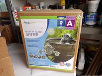 Front of boxed AquaScape Man in a Barrel Spitter
