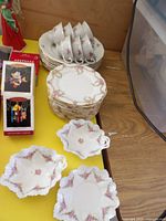 Group shot of stacked plates, cups and leaf bowls