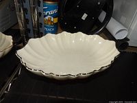 Oblong ivory ceramic serving bowl, scalloped design, platinum rim