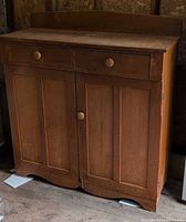 Front view showing full cabinet, drawers, doors, knobs