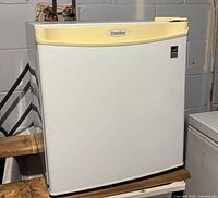 Front view of white Danby mini fridge showing door, handle trim and Energy Star label