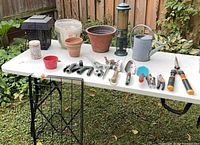 Overview of all gardening items on folding table outdoors