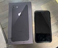 iPhone 8 handset beside its box, front screen visible