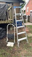 Full view of 6-ft step ladder and folded Cosco dolly/step ladder outdoors