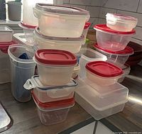 Stacked clear plastic containers with red lids