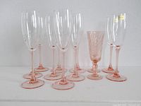 Group of 12 pink champagne flutes showing height and styles