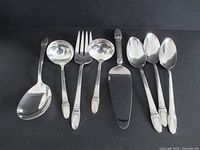 All eight serving pieces arranged on dark background