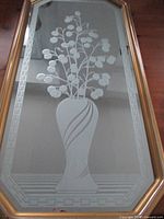 Full view of elongated octagon mirror showing etched vase and foliage design
