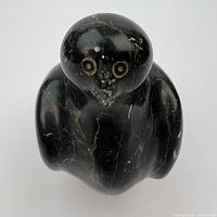 Front top view of soapstone ptarmigan showing eyes and beak chip