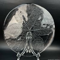 Front view of clear glass platter showing embossed leaf design
