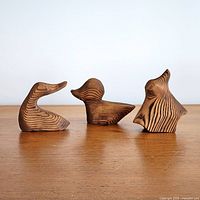 Front view of three GERD wooden bird carvings