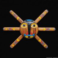 Front view of painted wooden sun mask with six rays