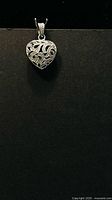 Front view of sterling silver heart filigree pendant