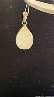 Front view of sterling silver teardrop pendant with mother of pearl