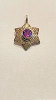 Front view of sterling silver star charm showing amethyst stone