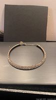 Full view of rhinestone choker laid flat showing entire circumference and clasp