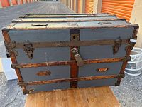 Front view showing canvas panels, wood slats, metal hardware, latch, side handles