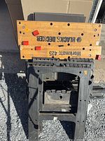 Collapsed Workmate 425 with stacked folding sawhorses visible