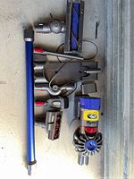All Dyson V11 components laid out: motor unit, wand, cleaner heads, attachments