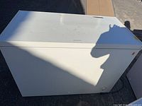 Front and top view of white Frigidaire chest freezer showing overall size and power cord