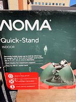 Retail box front showing brand, model, features, and image of green tree stand