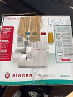Retail box for Singer 14CG754 ProFinish serger showing product image and specifications