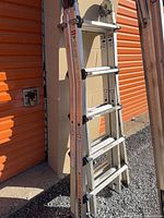 Full view of folded ladder showing rungs, hinges, rails