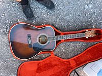 Full view of Yamaha FG-355SB guitar resting inside red plush hard case