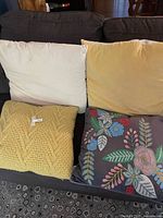 Four pillows on sofa showing colours and styles