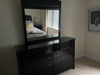 Dresser with attached mirror in bedroom setting