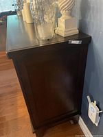 Left side view of dark wood buffet showing overall finish and side panel