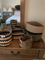 All four woven baskets grouped on dresser