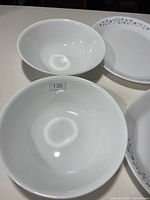 Two white Corelle bowls and one platter edge visible