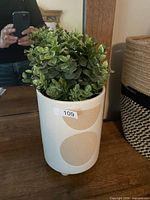 Planter with artificial plant, exterior view