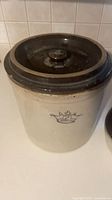 Large beige crock with lid showing crown mark