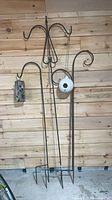 All three metal hooks with both bird feeders hung for scale