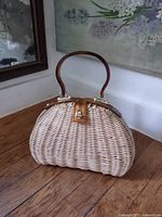 Front view of wicker handbag showing overall shape and handles