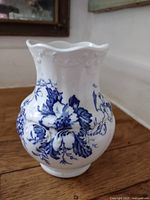 Front view of white pottery vase with blue floral pattern