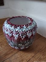 Overall view of pottery flower bowl showing floral relief and multicolour glaze