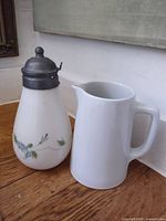 Both vessels side by side on wood floor